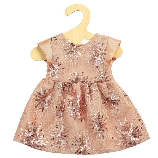 Das Kleid ist rosa und hat Pailletten drauf