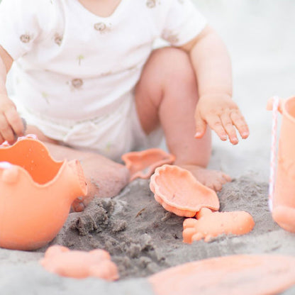 Kleinkind spielt mit Sandformen in Moral von Scrunch